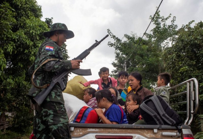 A member of the insurgent KNDF Karenni Nationalities Defence Force rescues civilians trapped amid airstrikes, during a battle to take over Loikaw in Kayah State, Myanmar November 14, 2023. REUTERS/Stringer/File Photo