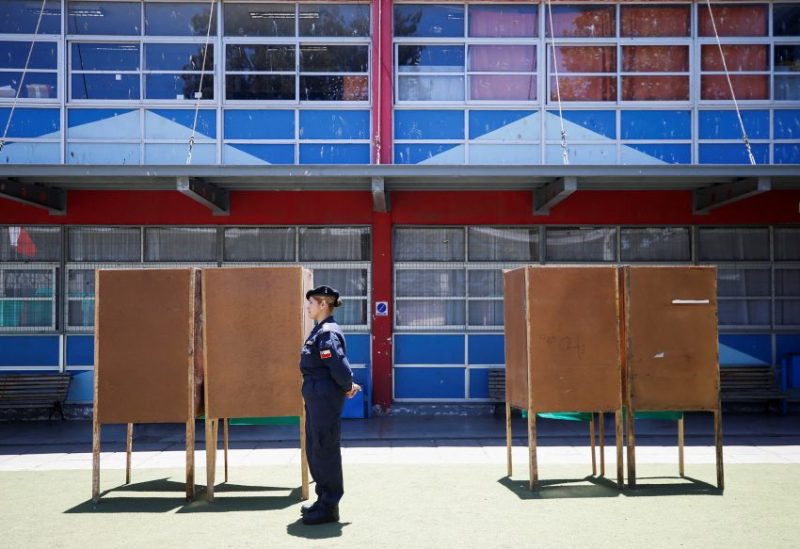 A Chilean Navy officer stands guard next to voting booths before the constitutional referendum which will be held on December 17, in Valparaiso, Chile, December 15, 2023. REUTERS/Rodrigo Garrido