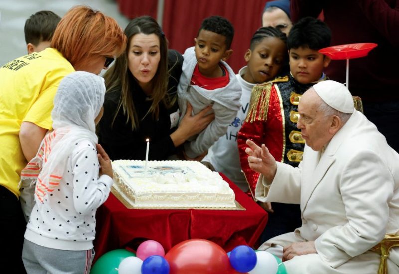 Pope Francis blows a candle on his cake for his 87th birthday, as he meets with a group of sick children from the "Santa Marta" Paediatric Dispensary at the Vatican, December 17, 2023. REUTERS/Remo Casilli