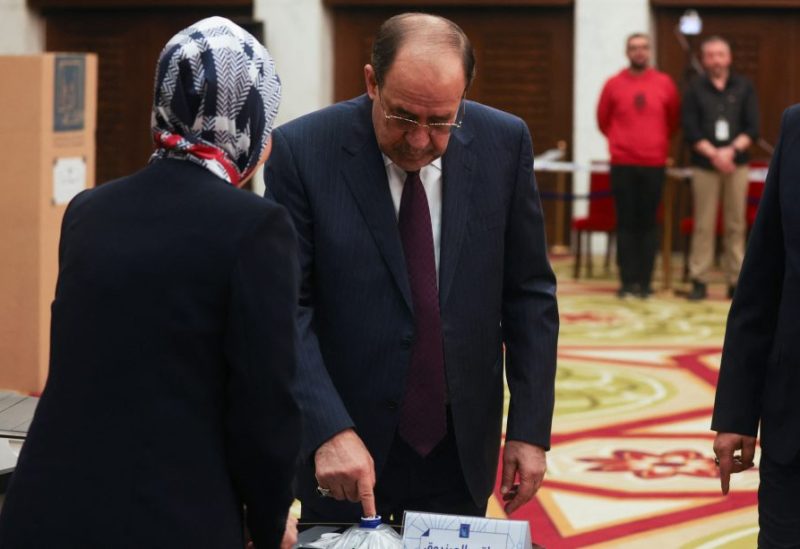 Former Iraqi Prime Minister Nouri al-Maliki dips his finger in the ink at a polling station, as he votes in Iraq's provincial council elections, in Baghdad, Iraq, December 18, 2023. REUTERS/Ahmed Saad