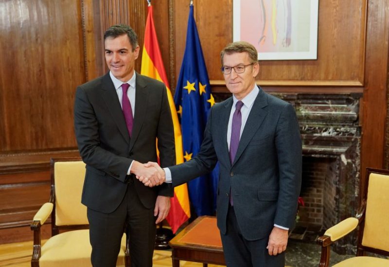 Spain's Prime Minister Pedro Sanchez shakes hands with Spain's opposition leader Alberto Nunez Feijoo as they pose for the media on the day of their meeting at the Parliament in Madrid, Spain, December 22, 2023. REUTERS/Ana Beltran