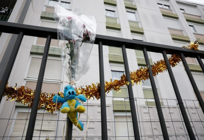 A bunch of flowers is placed on the fence, in front of the ground floor flat where the bodies of a woman and her four children where discovered, in Meaux, northeast of Paris, France, December 26, 2023. REUTERS/Benoit Tessier