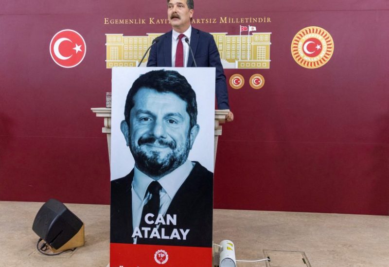 Erkan Bas, the leader of Workers' Party of Turkey (TIP) speaks near a portrait of Can Atalay, a jailed MP of TIP, at the Turkish parliament in Ankara, Turkey, June 2, 2023. Atalay has not been released despite a law that opens a way for jailed politicians to be released from prison if they are elected to parliament. REUTERS/Umit Bektas/File Photo