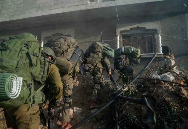 Israeli soldiers operate in the Gaza Strip amid the ongoing conflict between Israel and the Palestinian Islamist group Hamas, in this handout picture released on December 28, 2023. Israel Defense Forces/Handout via REUTERS