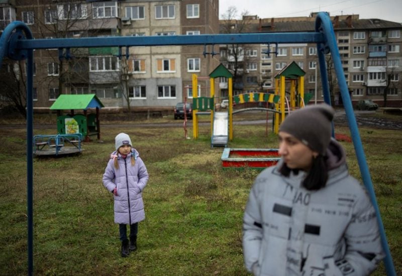 Iryna and her daughter, third-grader Arina, stand in a playground after an online reading class in Sloviansk, amid Russia's attack on Ukraine, December 20, 2023. Ukrainian third-grade student Arina has had just over 1,5 months of in-class schooling because of the war that poses the regular threat of Russian air strikes on schools. REUTERS/Thomas Peter