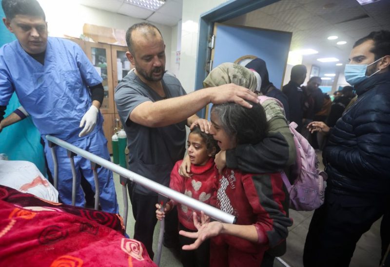 People react next to the bed of a Palestinian wounded in an Israeli strike, at a hospital in Khan Younis, amid the ongoing conflict between Israel and the Palestinian Islamist group Hamas, in the southern Gaza Strip, December 28, 2023. REUTERS/Ahmed Zakot