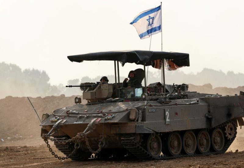 Israeli soldiers ride a military vehicle, amid the ongoing conflict between Israel and the Palestinian Islamist group Hamas, near the Israel-Gaza border, in southern Israel, December 28, 2023. REUTERS/Violeta Santos Moura