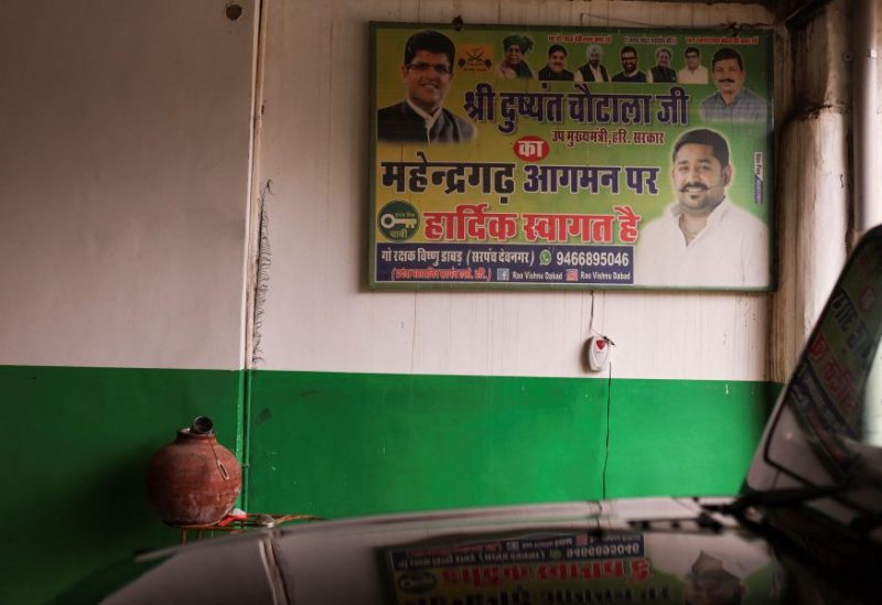 A political hoarding hangs on the wall of the guest house of Vishnu Dabad, 30, a Gau Rakshak or a cow protector and politician with the regional political party Jannayak Janta Party(JJP), in Chamdhera village, Haryana, India, November 10, 2023. REUTERS/Anushree Fadnavis