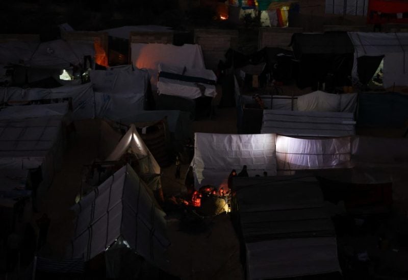 Displaced Palestinians, who fled their homes due to Israeli strikes, shelter in a tent camp, amid the ongoing conflict between Israel and the Palestinian Islamist group Hamas, on the eve of the new year of 2024, in Rafah, southern Gaza Strip, December 31, 2023. REUTERS/Ibraheem Abu Mustafa