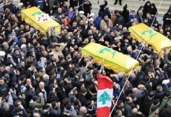 Mourners carry the coffins of a Hezbollah fighter and other two civilians who killed by an Israeli airstrike that hit their house Tuesday night, in Bint Jbeil, South Lebanon, Wednesday, Dec. 27, 2023. (AP Photo/Mohammed Zaatari)