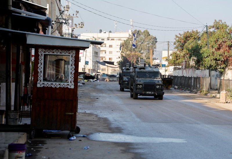 An Israeli military vehicle manoeuvers on a road during a raid in Jenin, in the Israeli-occupied West Bank December 12, 2023. REUTERS/Raneen Sawafta