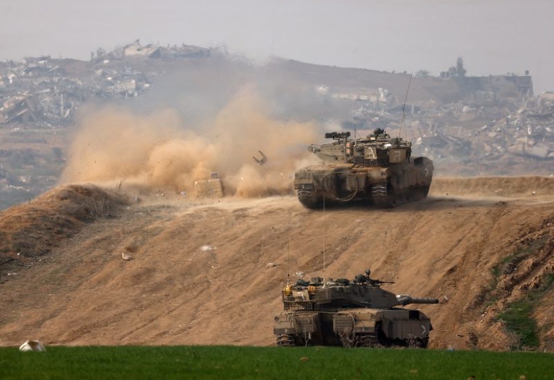 An Israeli tank fires towards Gaza, amid the ongoing conflict between Israel and the Palestinian Islamist group Hamas, at the Israel-Gaza border, in southern Israel, December 27, 2023. REUTERS/Amir Cohen