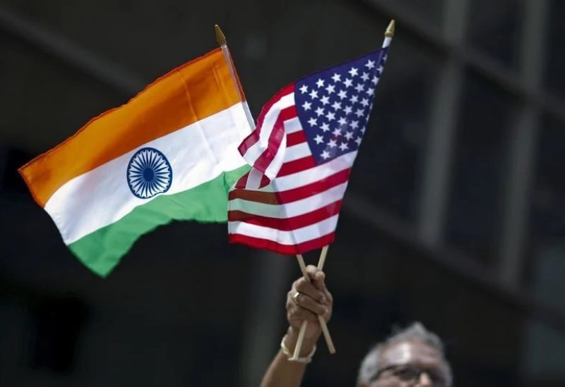 A man holds the flags of India and the U.S. while people take part in the 35th India Day Parade in New York August 16, 2015. REUTERS/Eduardo Munoz/ File Photo