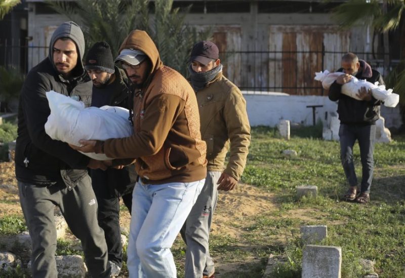 Palestinians carry the bodies of the Dhair family, killed in the Israeli bombardment of the Gaza Strip, during their funeral in Rafah on Friday, Dec. 22, 2023. (AP Photo/Hatem Ali)